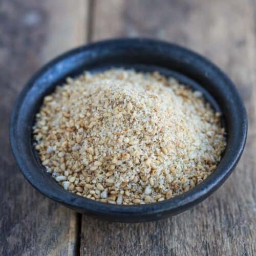 ground sesame seeds and salt in small black bowl