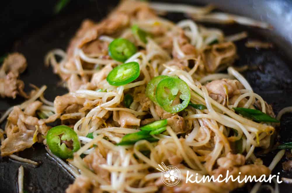 cooked pork belly bean sprouts with jalapeno peppers in pan