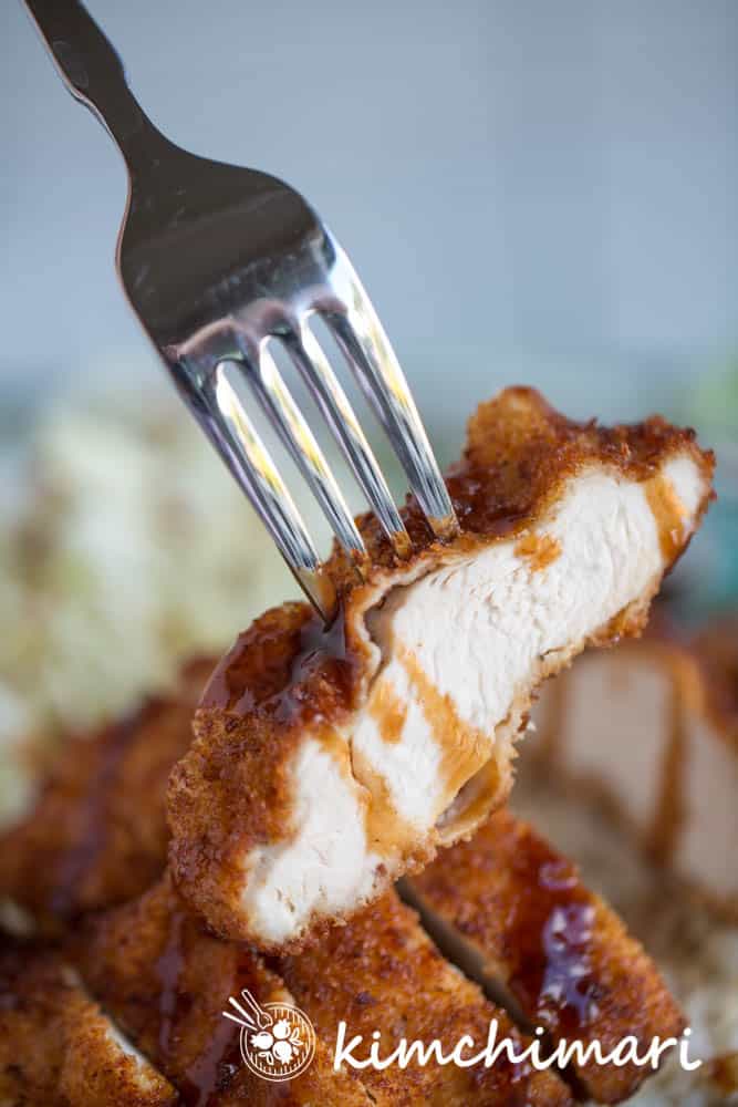 closeup of cross section of chicken katsu in fork