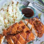 chicken katsu sliced and plated with rice and cabbage slaw