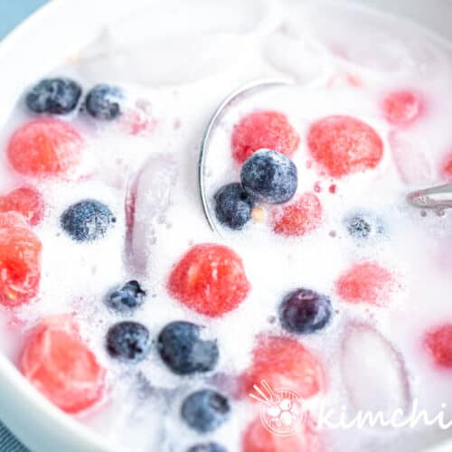 korean watermelon punch with watermelon balls, blueberries in milky liquid with ice