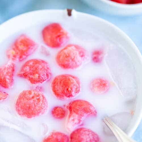 watermelon punch in white milky liquid in bowl with spoon