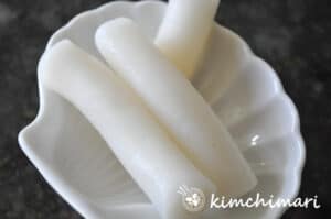 fresh tteokbokki rice cakes on small white plate