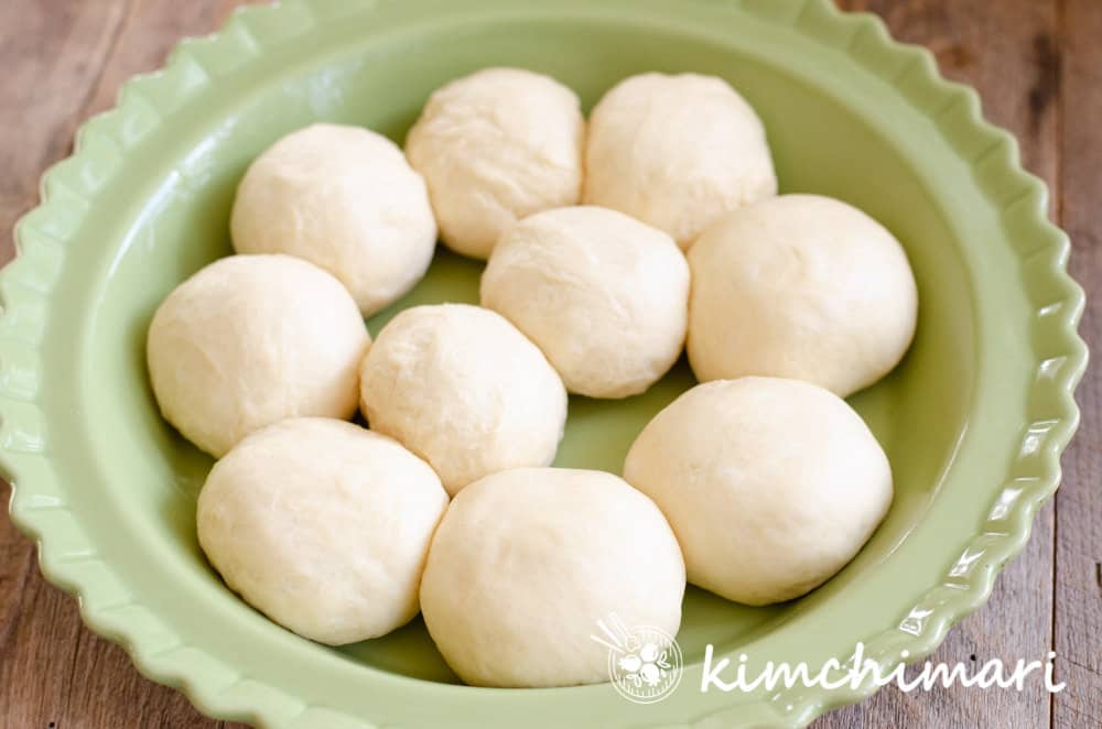dough balls in pie dish for milk bread dinner rolls
