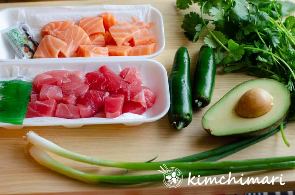 poke salmon tuna jalapenos cilantro avocado green onions on cutting board