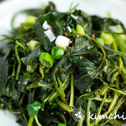 close up of chwinamul sauteed aster scaber leaves in white dish