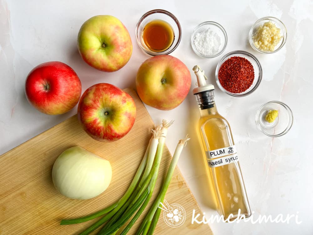 ingredients for apple kimchi laid out on cutting board
