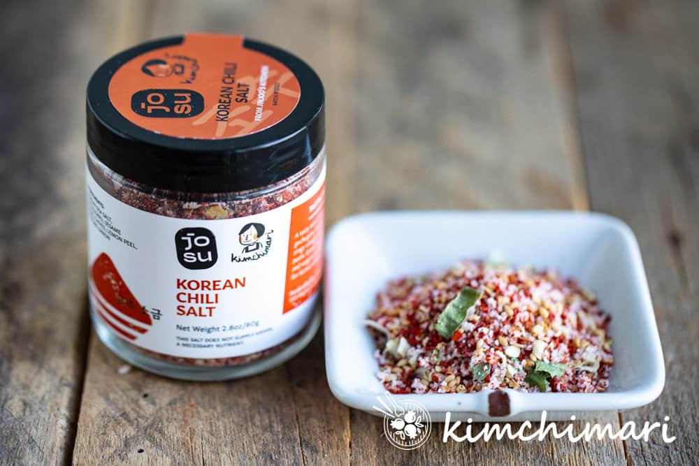 kimchimari korean chili salt jar and small dish full of it