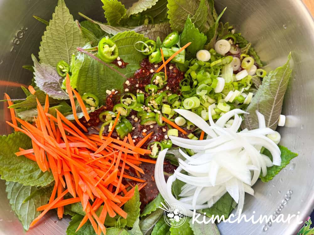 carrots, onions, chili peppers, garlic, ginger added to perilla kimchi mix
