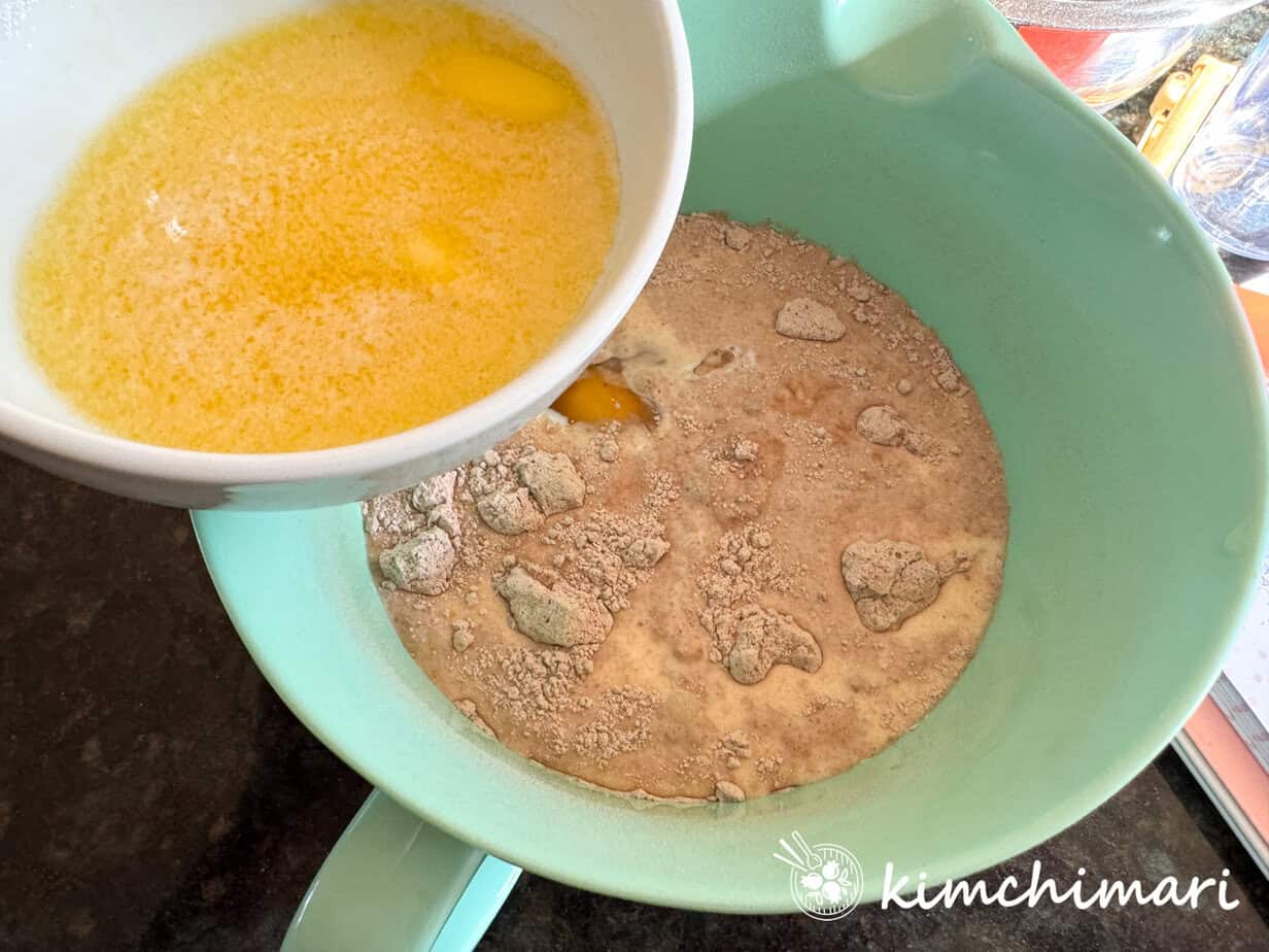 butter being poured onto bowl with dry mochi brownie ingredients