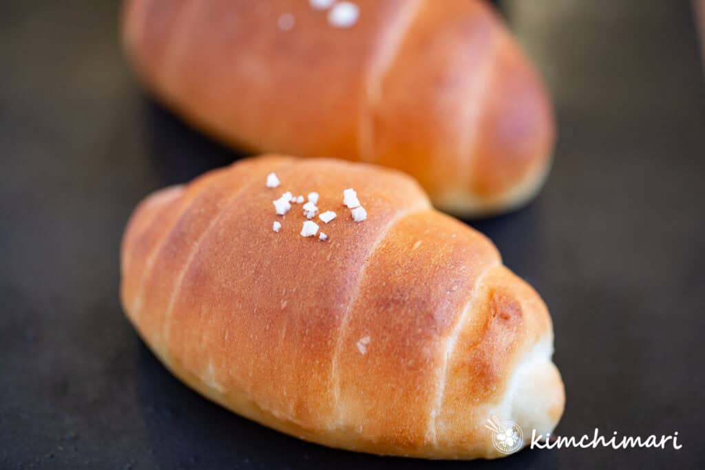 close up of salt bread on black baking pan using JinJoo's recipe